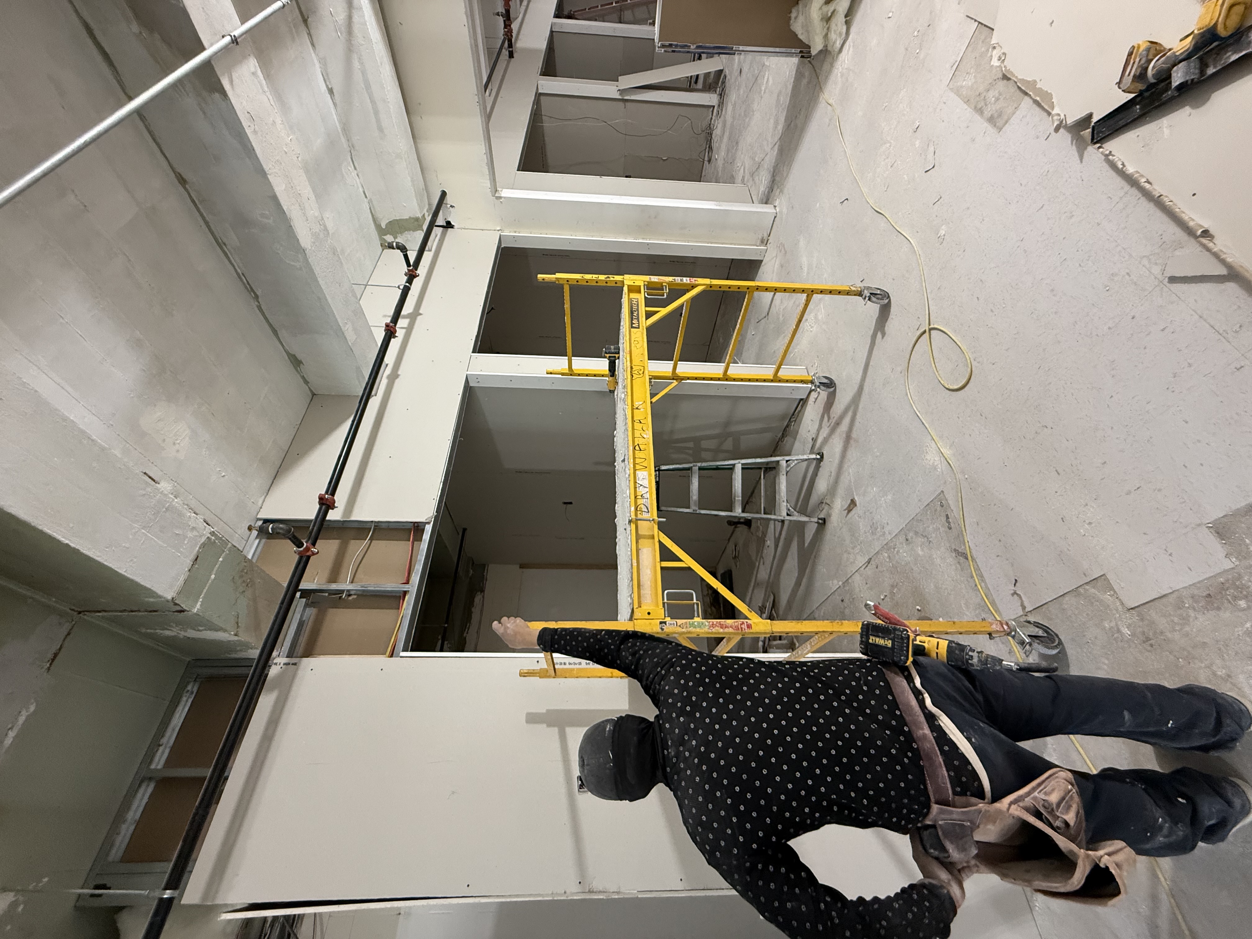 Worker pointing at soffit near scaffold
